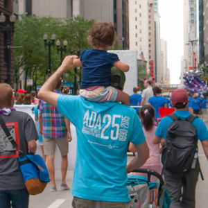 IDHD faculty Brian Grossman with his daugther at the 2015 Chicago Disability Pride Parade