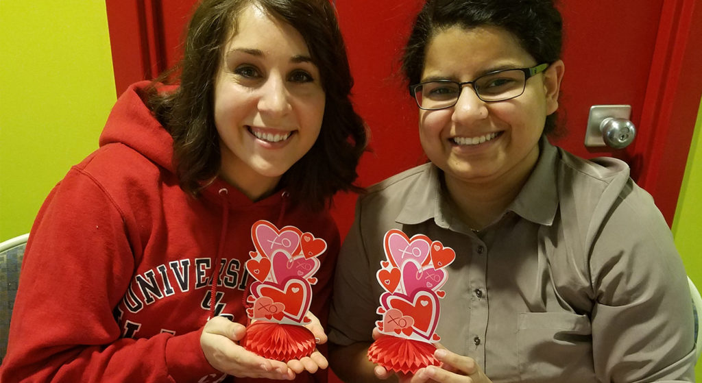 Nutrition students Renee Jeffrey and Urooj Riaz selling baked goods during SNA's Valentine's Day Bake Sale