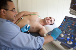 Mohamed Ali, PhD student, administers ultrasound to fellow PhD student, AJ Rosenberg