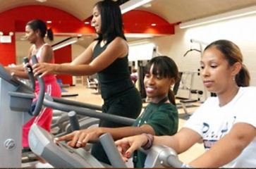 African American women exercising on treadmills at a park facility